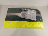 the yellow and green shirt is wrapped in plastic on a white table
