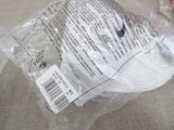 a white hat that is wrapped in plastic on the floor