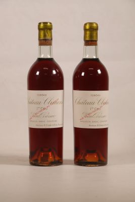 two bottles of wine sitting next to each other on a table