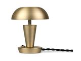 a gold table lamp with a black cord on a white background