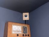 a radio on top of a shelf in the corner of a room