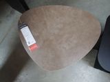 a table with a label on it and a chair in the background