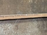 a picture of a piece of wood with writing on it
