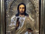 a close up of a painting of jesus holding a book