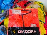 a pile of assorted clothing on a white surface