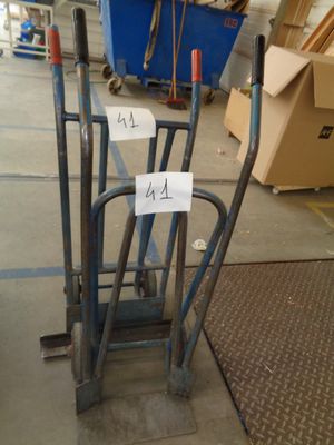 a pile of luggage sitting on the floor in a warehouse