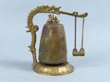 a brass bell with a chain hanging from it ' s neck