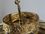 a gold umbrella with a key on top of it