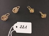 a close up of a tag on a table with a bunch of earrings
