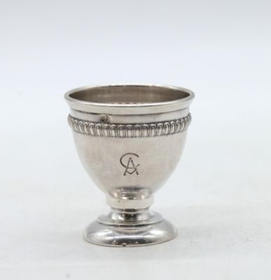 an antique silver cup with a monogram on the side