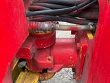 a red fire hydrant with a hose attached to it