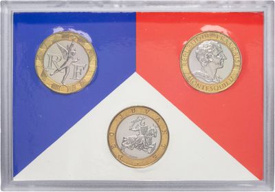 a close up of two different coins in a glass case