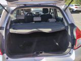 the back of a car with its trunk open in a parking lot