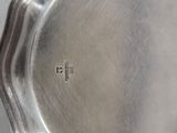 a silver pan with a handle on a table