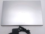 a silver laptop with a charger attached to it