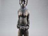 an image of a statue of a woman with a large headpiece