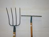 two different types of garden tools hanging on the wall