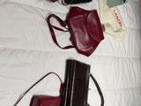 a lot of purses sitting on a bed together