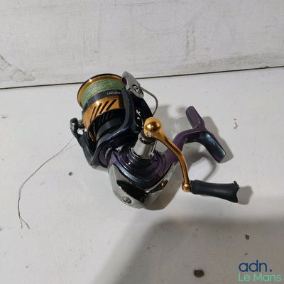a fishing rod and a reel sitting on a table