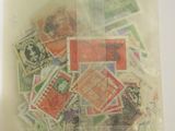 a bag of stamps on a table with a white background