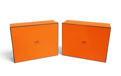 two orange boxes that are sitting next to each other on a white surface