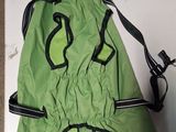 a green dog coat with a black zipper on it