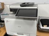 a printer sitting on top of a desk in a room