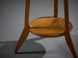 a close up of a wooden table with a round top