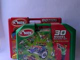 three boxes of k ' nex toys sitting on a table