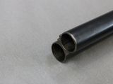 a close up of a black pipe on a white surface