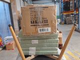 a stack of boxes on top of a pile of chairs in a warehouse