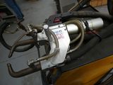 a close up of a motorcycle with a hose attached to the back of it