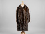 a brown fur coat on a mannequin stand