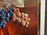 a painting of a bunch of grapes on a table