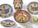 many different types of decorative plates and bowls on the table