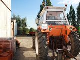 a tractor that is parked next to a building