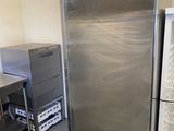 stainless steel refrigerator in a commercial kitchen with stainless steel counter tops