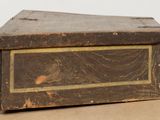 an old wooden box sitting on top of a cardboard box