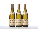 three bottles of wine sitting on top of a white table