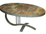 the table is made of metal and has a stone top