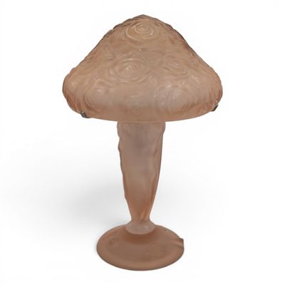 a glass mushroom on a pedestal on a white background