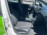 the interior of a small car with the door open and the passenger seat down