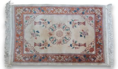 an antique rug with a floral design and fringes on a white background