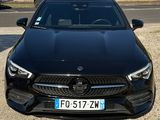 the front view of a black mercedes cla parked in a parking lot