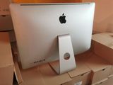 a white apple computer sitting on top of a cardboard box