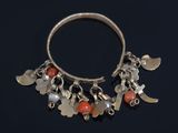 a close up of a silver bracelet with charms on it