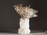 a statue of an owl sitting on top of a rock
