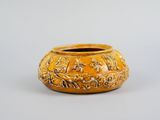 an image of a yellow vase sitting on top of a table