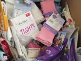a cardboard box full of children ' s clothing and socks