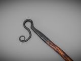 a long wooden stick with a black handle on a table